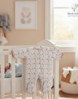 Mothers Choice Quilted Grower 'Pink Rainbow' baby sleepsuit with rainbow pattern, pink trim, and footies. Cozy and soft.