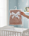 Stork and Baby pink single layer sherpa fleece blanket with ribbed texture, tied with a white ribbon.