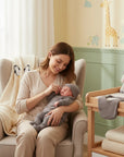 Stork And Baby Stone Preemie 5 Piece Set: A mother holds her newborn baby dressed in a grey ribbed outfit and hat.