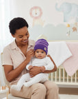 Stork And Baby purple striped knit winter hat on infant. Soft, cozy, and lightweight.