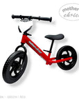 Stork And Baby red toddler balance bike with black wheels and seat, featuring a checkered flag detail on the handlebars.