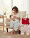 Stork And Baby red and white polka dot velour baby grower with scalloped red bib detail and bow accents.