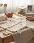Stork And Baby infant boys 3 piece natural safari set in cream with animal prints. Includes a long-sleeve top, pants, and a vest.