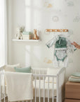 Stork And Baby Sage/Grey Leaf newborn starter pack with onesie, hat, mittens, and bodysuit in soft cotton.