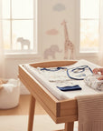 Stork And Baby 8-piece newborn gift set with tractor theme, including bodysuit, t-shirt, bottoms, bib, cap, blanket, and washcloths.