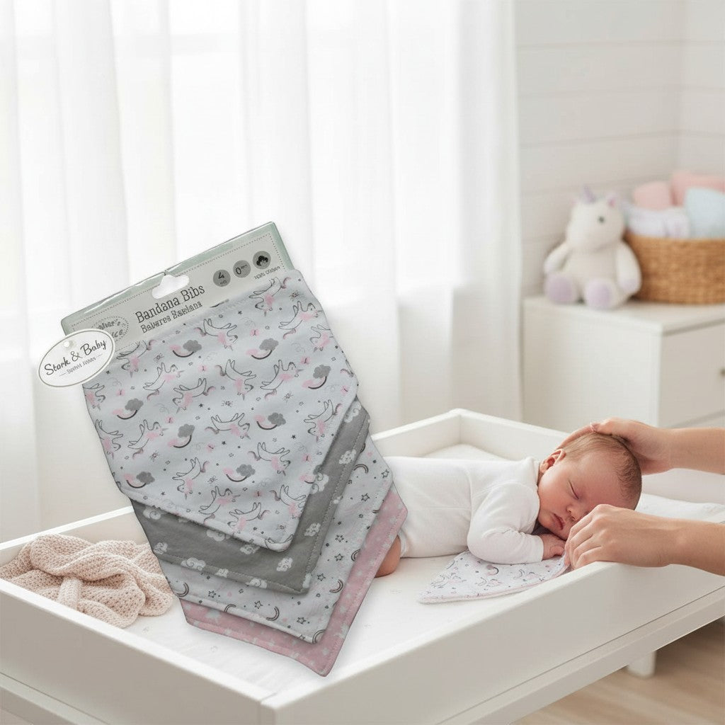 Stork And Baby 4 pack infant girls bandana bibs with unicorn and cloud print in pink, grey, and white. 100% cotton.
