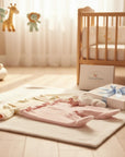 Stork And Baby beige and pink velour baby growers with pram detail. Soft, cozy, and perfect for naps.