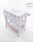 Stork And Baby white baby bath caddy with pink star pattern storage shelf and wheels for easy mobility