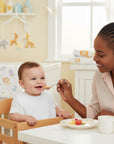 Stork And Baby white double knit baby bib with velcro closure for feeding time spills and drool.