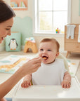 Stork And Baby white bib with PVC backing and velcro closure for baby feeding time.