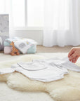 Stork And Baby white 3-piece long sleeve bodysuit set with bib, made from soft, breathable fabric for newborns.
