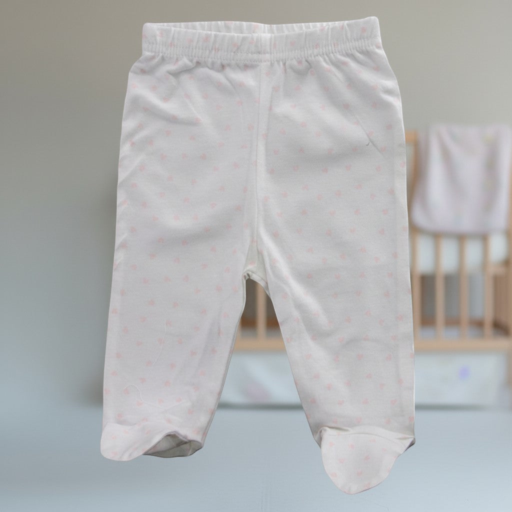 Stork And Baby white 100% cotton baby leggings with pink hearts print, footed design.