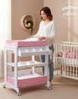 Stork And Baby white and pink star print baby bath caddy with changing mat and storage shelves in a nursery