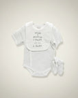 Stork And Baby white dotted romper with bib and mittens. Bib says "when I growup, I WANT to be... A BABY".